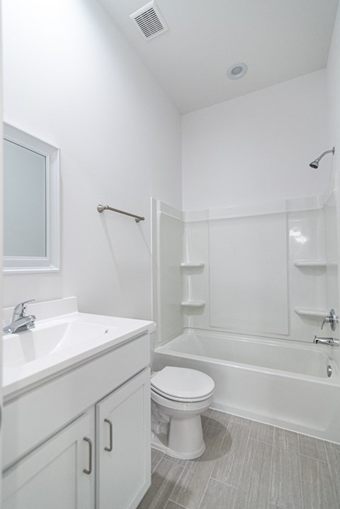 a bathroom with a toilet and a sink and a shower