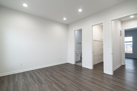 an empty living room with white walls and wood flooring