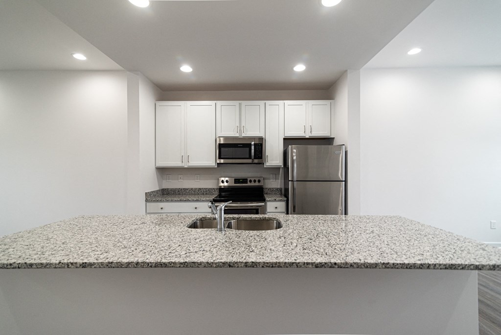 a kitchen with granite counter top and stainless steel appliances