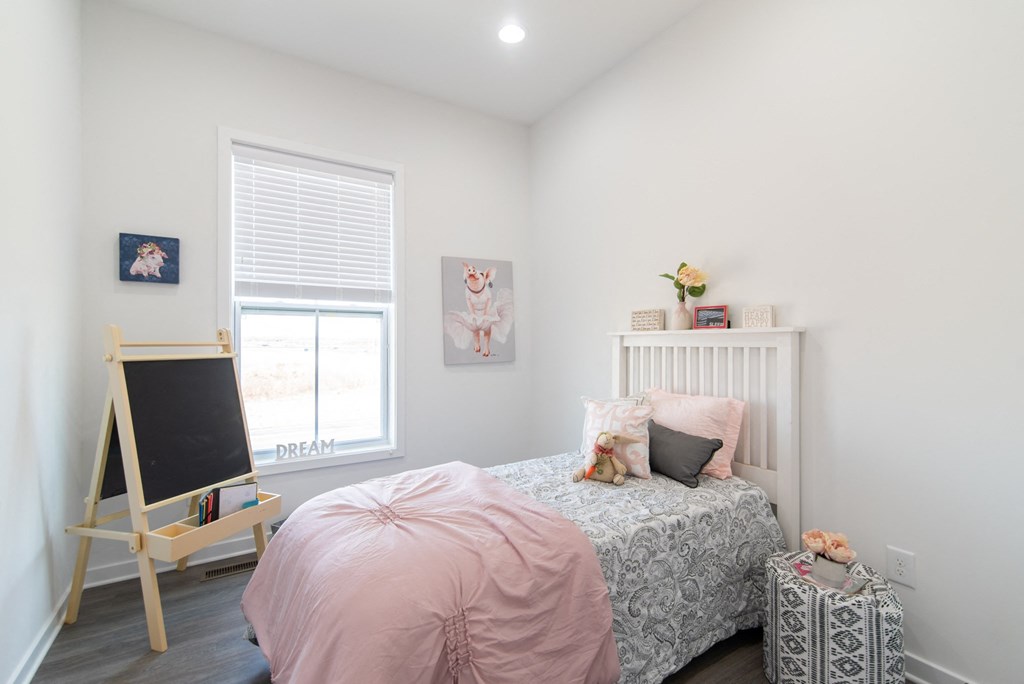 a bedroom with a bed and a window