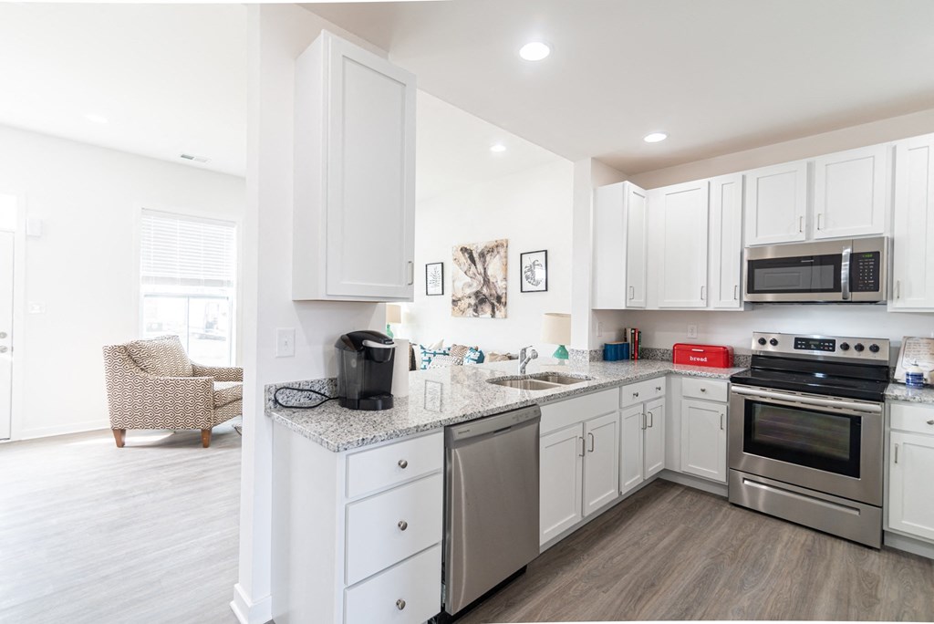 a kitchen with stainless steel appliances and white cabinets