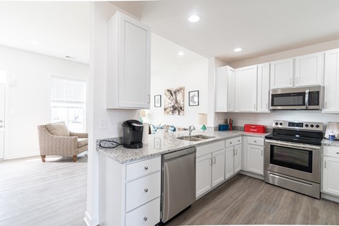 a kitchen with stainless steel appliances and white cabinets