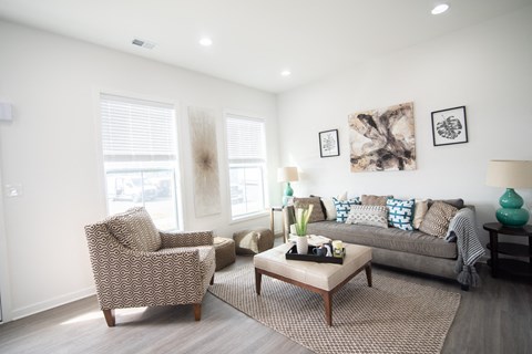 a living room with a couch and two chairs