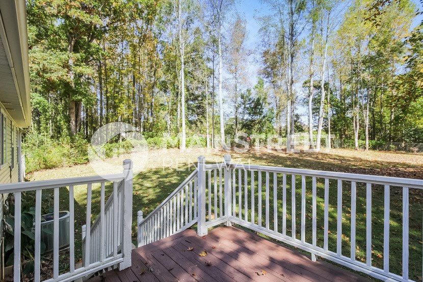 a view of the yard from the deck of a house