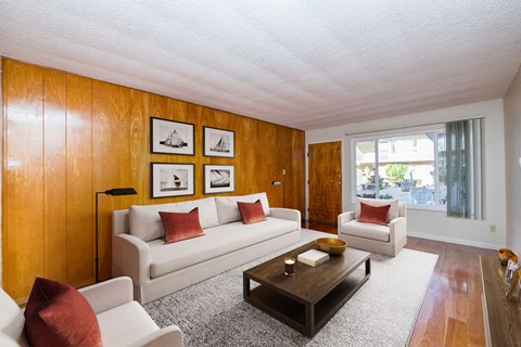 A living room with a white couch and a coffee table.