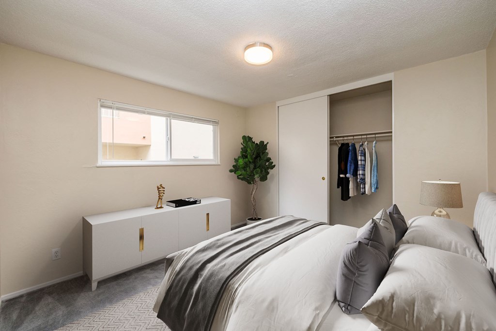 a bedroom with a bed and a closet and a window