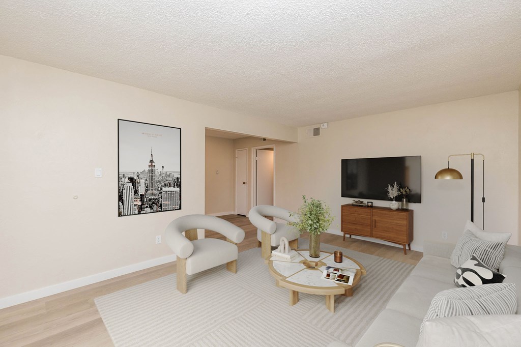 A living room with a couch, chair, and coffee table.