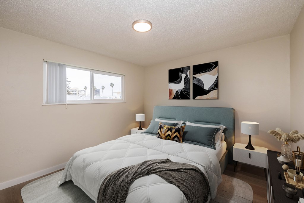 A bedroom with a large bed and a painting on the wall.
