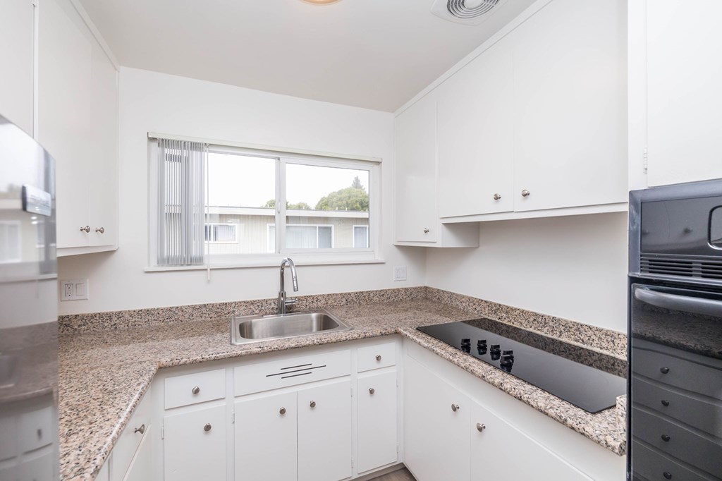A kitchen with a sink and a window.