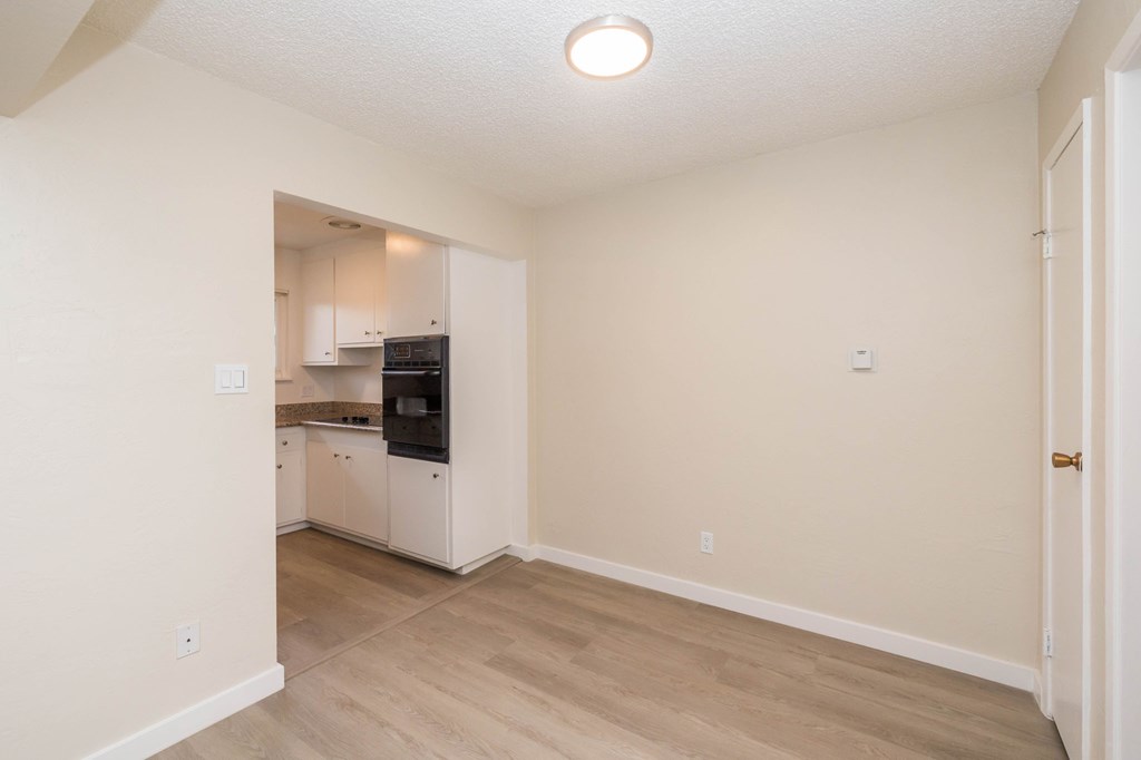 A kitchen area with a refrigerator, microwave, and oven.