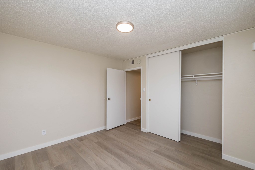 A room with a white ceiling and a wooden floor.