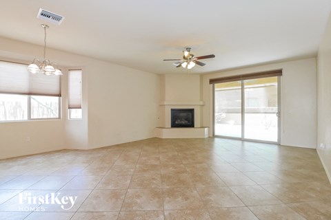 A spacious living room with a fireplace and sliding glass doors.