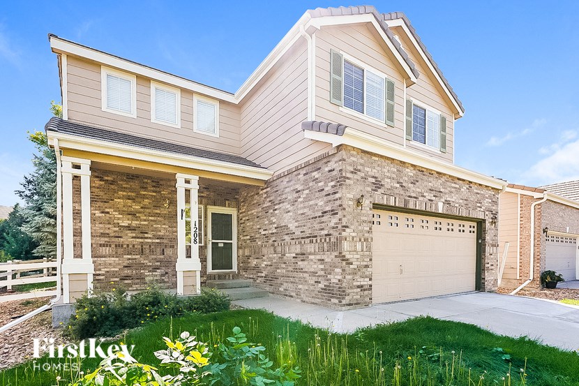 A house with a stone wall and a garage door.