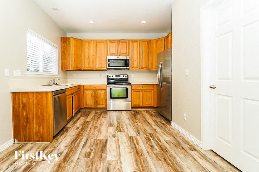 A kitchen with wooden cabinets and a white door.
