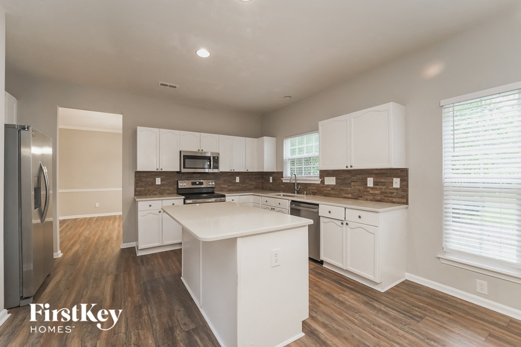 a kitchen with white cabinets and a white counter top
