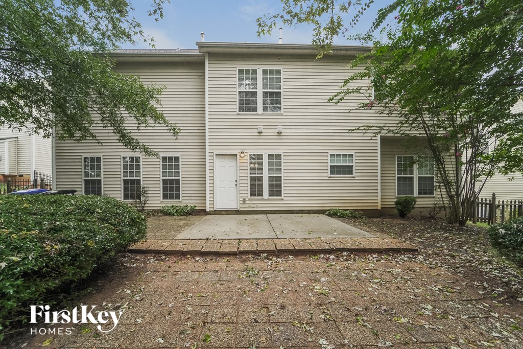 a white house with a sidewalk in front of it