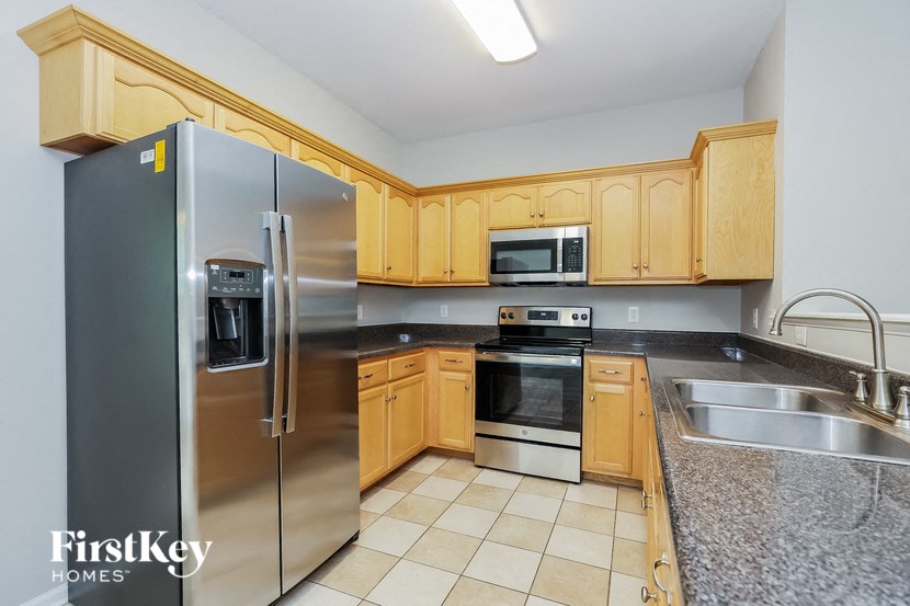 a kitchen with wooden cabinets and stainless steel appliances