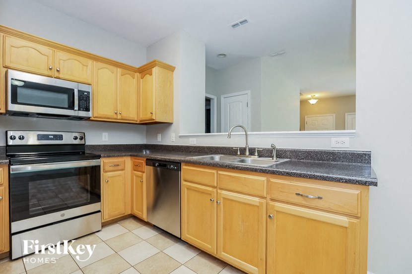a kitchen with wooden cabinets and stainless steel appliances
