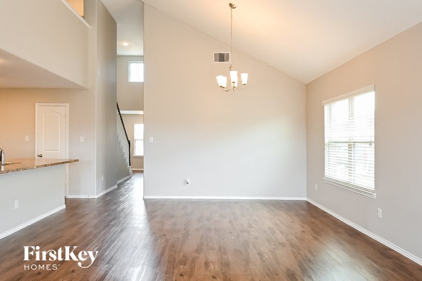 the living room and dining room with hardwood flooring