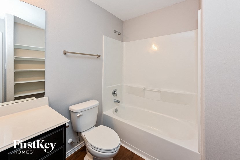 a bathroom with a tub and a toilet and a sink