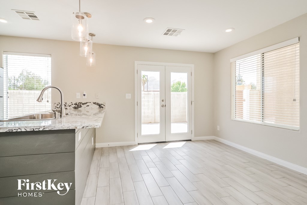 a kitchen with a marble counter top and a door to a patio