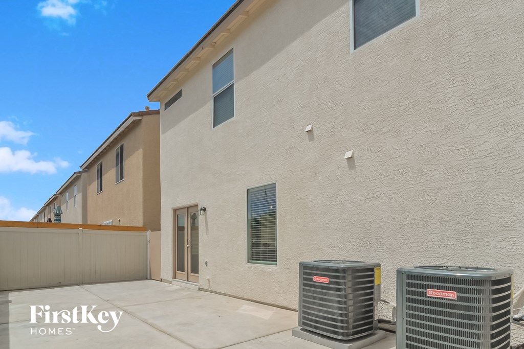 a large brick building with two cooling units in front of it
