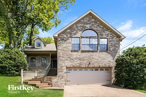 a brick house with a garage and a white garage door