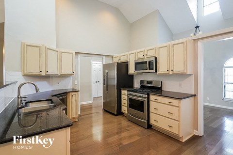 a kitchen with a stove and a refrigerator and a sink