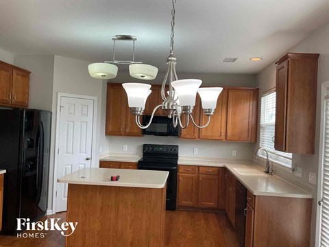 a kitchen with wooden cabinets and a chandelier