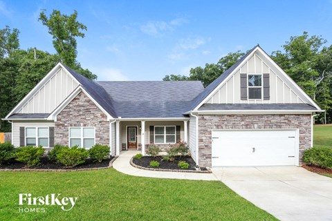 a white and brick house with a white garage door