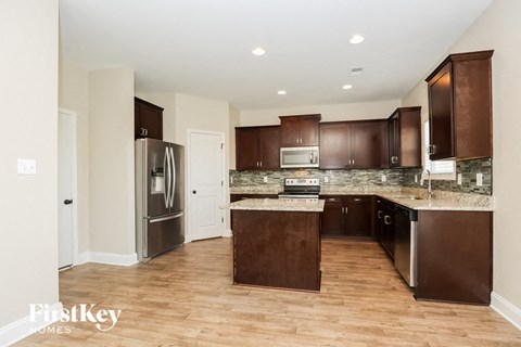 a kitchen with wooden cabinets and stainless steel appliances