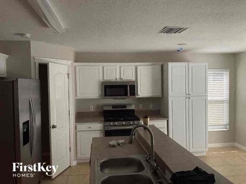 a kitchen with white cabinets and a sink