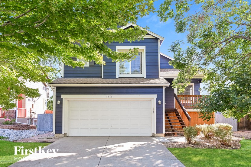 a blue house with a white garage door