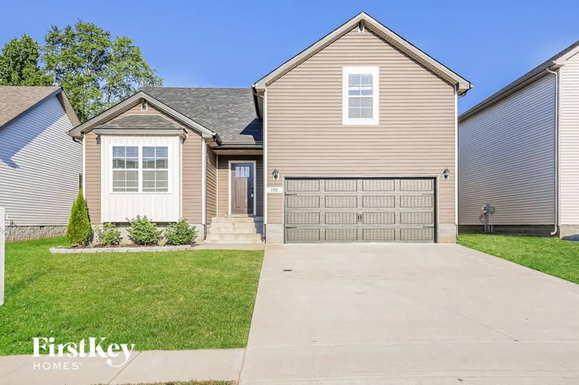 a house with a garage door in front of it