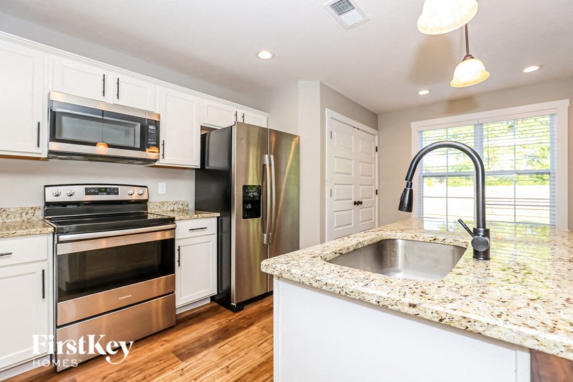 a kitchen with stainless steel appliances and granite counter tops