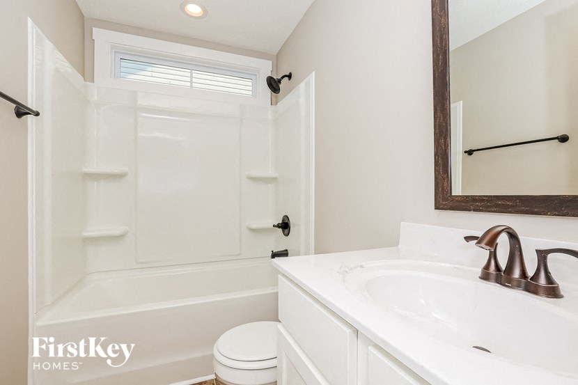 a bathroom with a sink and a toilet and a shower