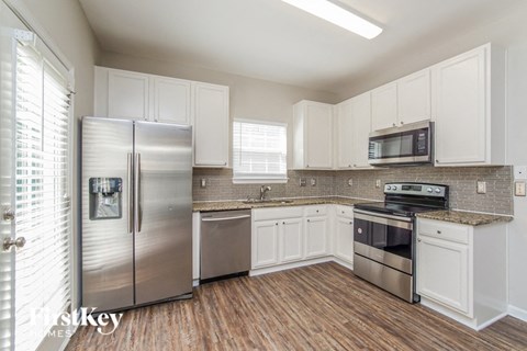 a kitchen with stainless steel appliances and white cabinets