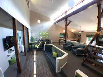 a large living room with furniture and a staircase