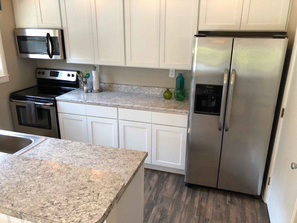 a kitchen with granite counter tops and stainless steel appliances