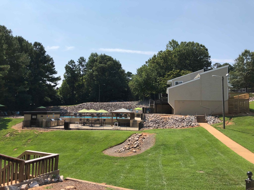 a view of a backyard with a picnic area and a pool