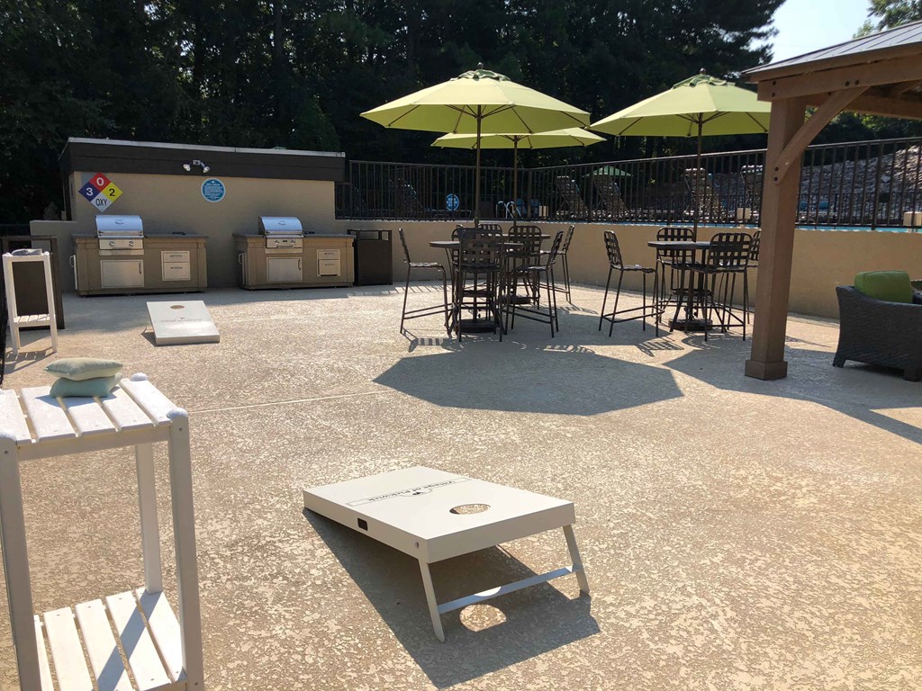 a patio with tables and chairs and umbrellas
