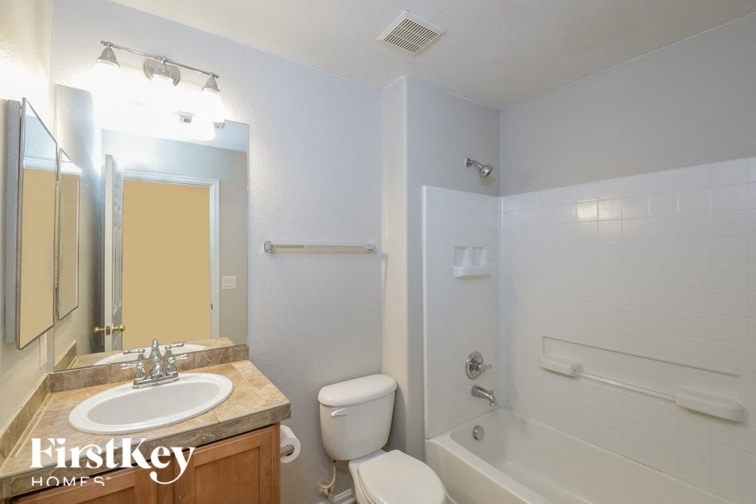 A bathroom with a sink, toilet, and bathtub.