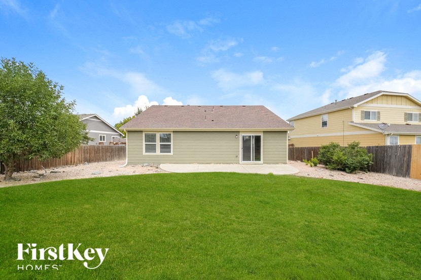 A house with a green lawn and a clear blue sky.