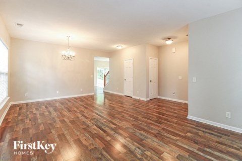 the living room and dining room with wood flooring