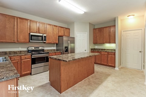 a kitchen with wooden cabinets and stainless steel appliances
