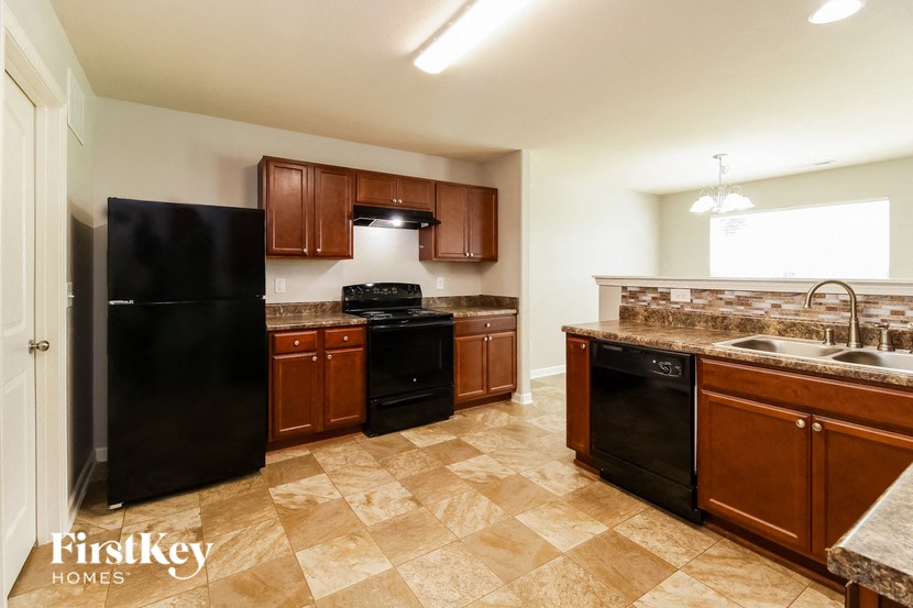 a kitchen with black appliances and wooden cabinets