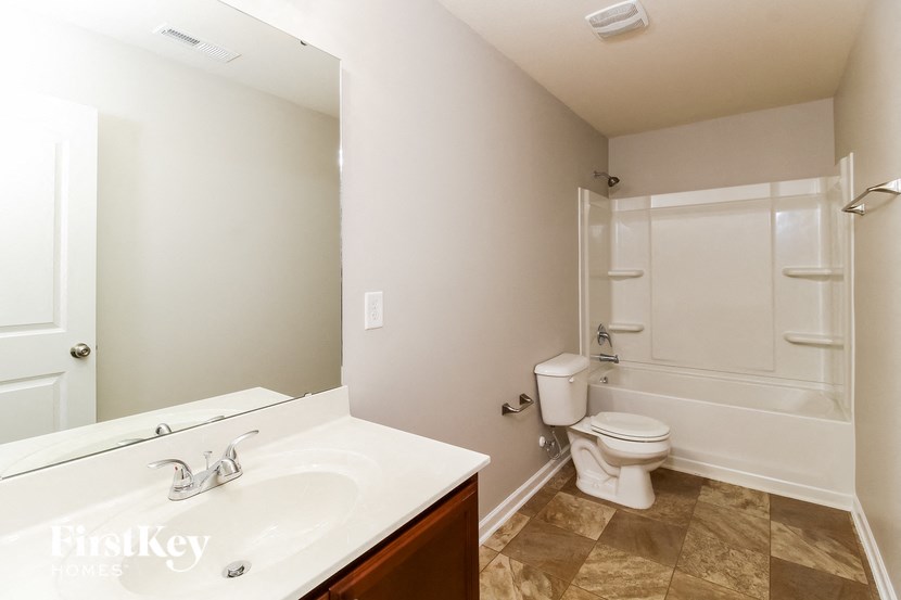 a bathroom with a toilet and a sink and a mirror