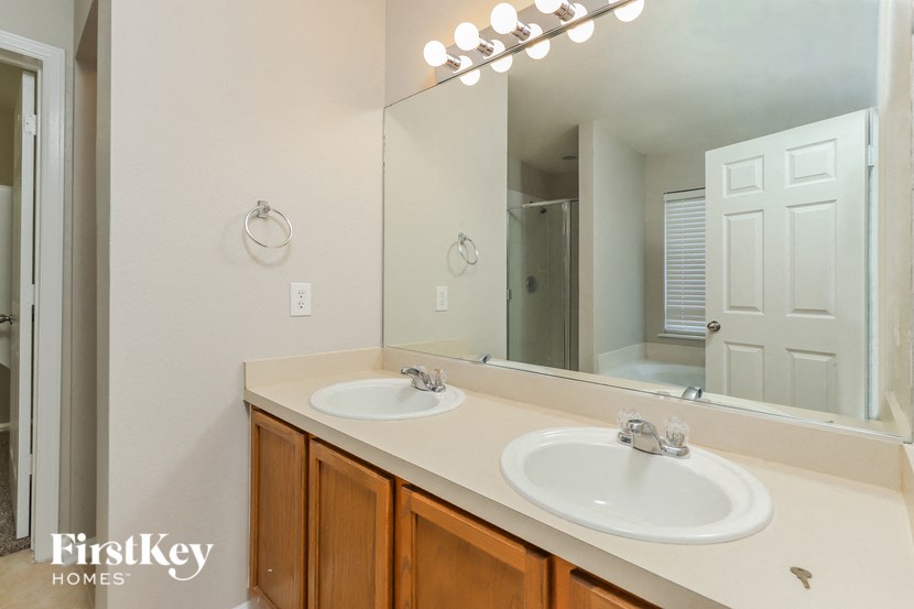 a bathroom with two sinks and a large mirror