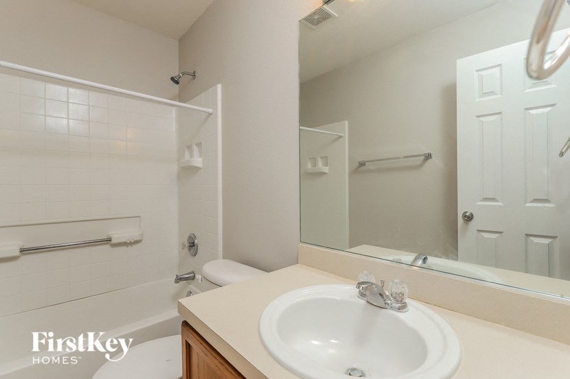 a bathroom with a sink and a mirror and a shower
