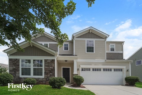 a house with a white garage door and a lawn